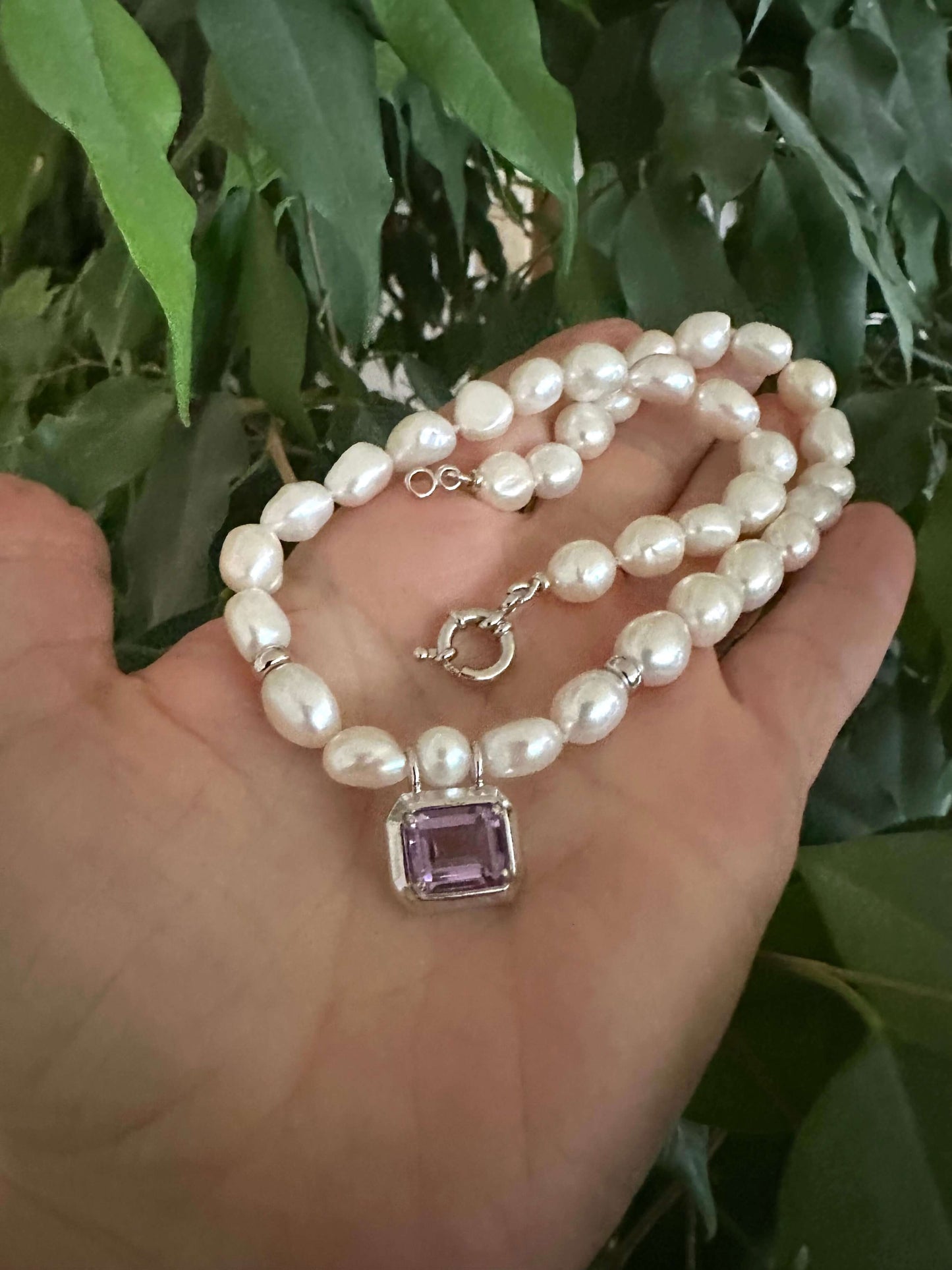 White Nugget Pearl Necklace with Amethyst Pendant – 'Viola' Collection held in hand, showcasing elegance and natural beauty.