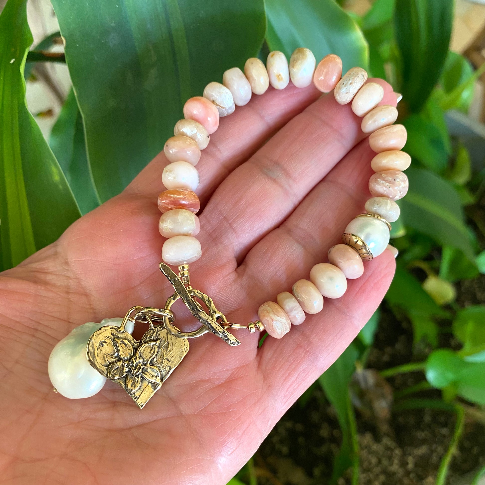 Pink opal bracelet with heart and baroque pearl charm handcrafted with smooth pink opal beads.