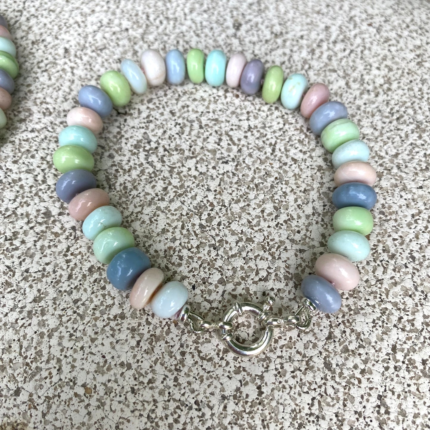 Opal candy bracelet featuring multi color Peruvian opal rondelle beads in pastel hues of green, pink, blue, and purple.