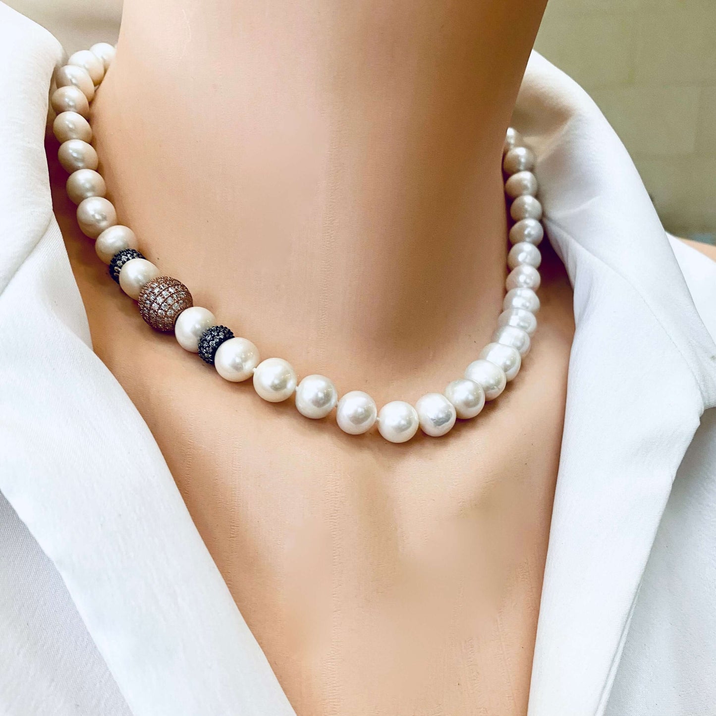 Bridal rose gold pearl necklace draped on mannequin, freshwater pearls and CZ pavé accents.