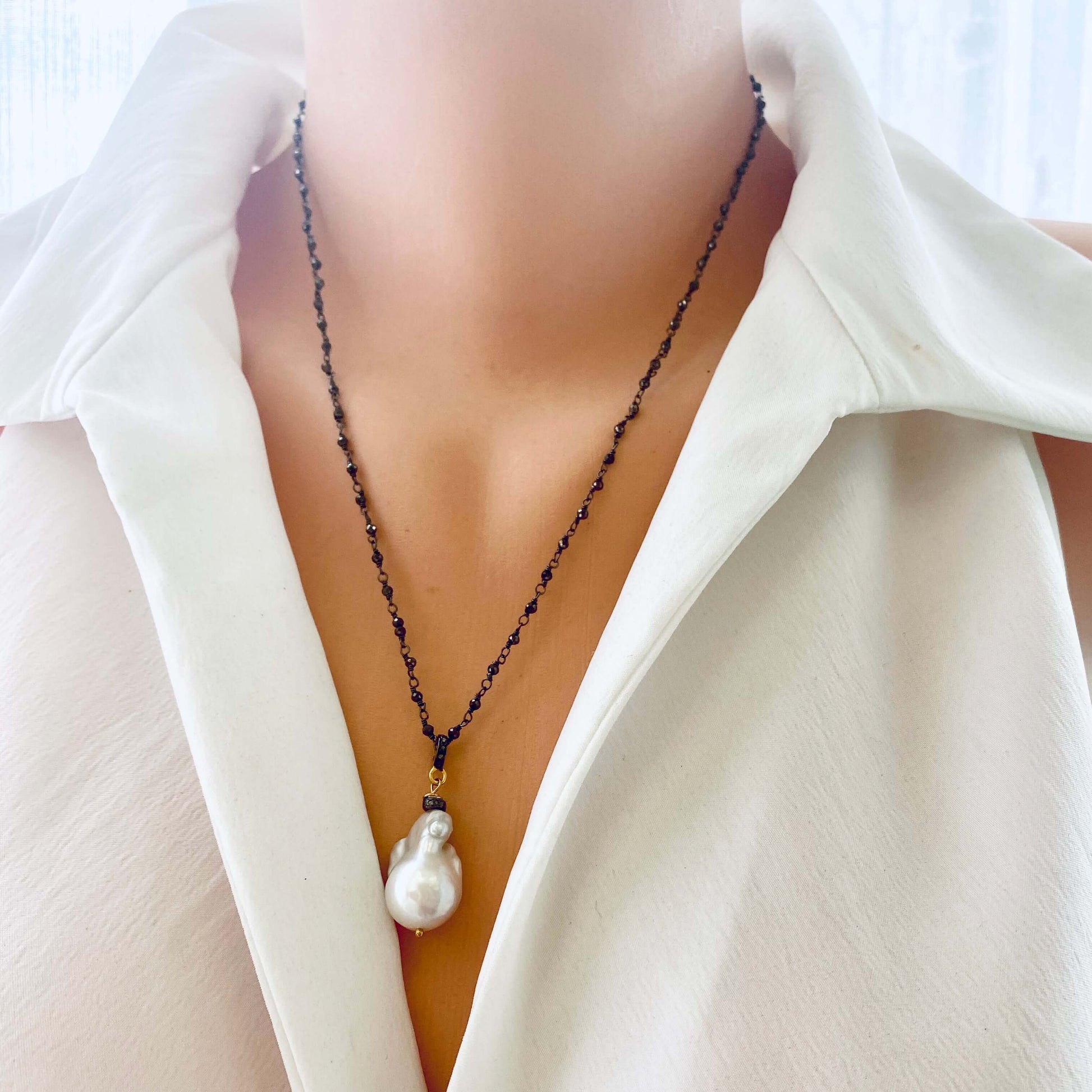 Pyrite rosary chain necklace worn by mannequin, frontal close-up highlighting diamond pavé connector