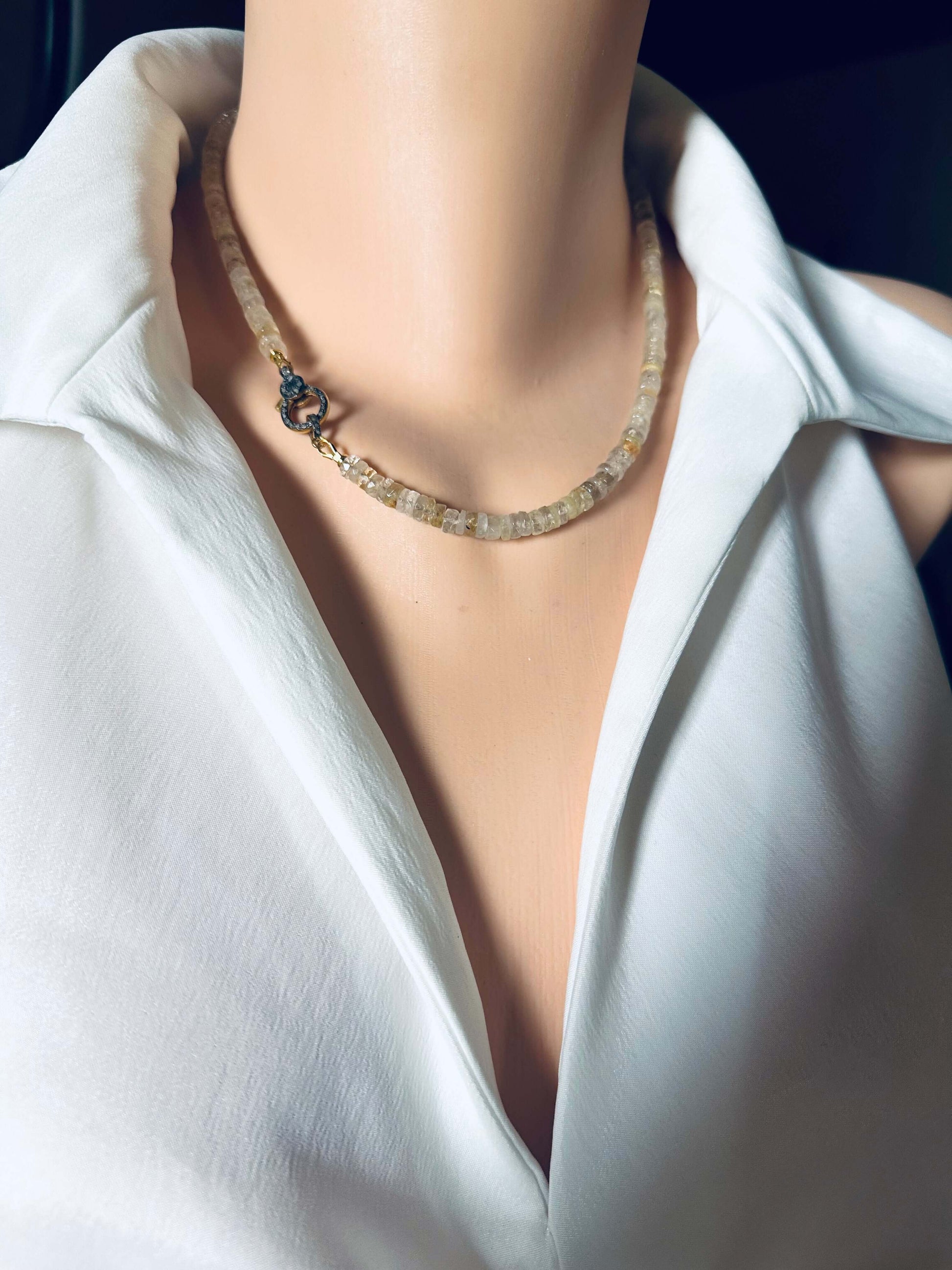 Rutilated Quartz Gemstone Necklace with Oxidized Vermeil Pavé Clasp displayed on a mannequin neck against a white shirt.