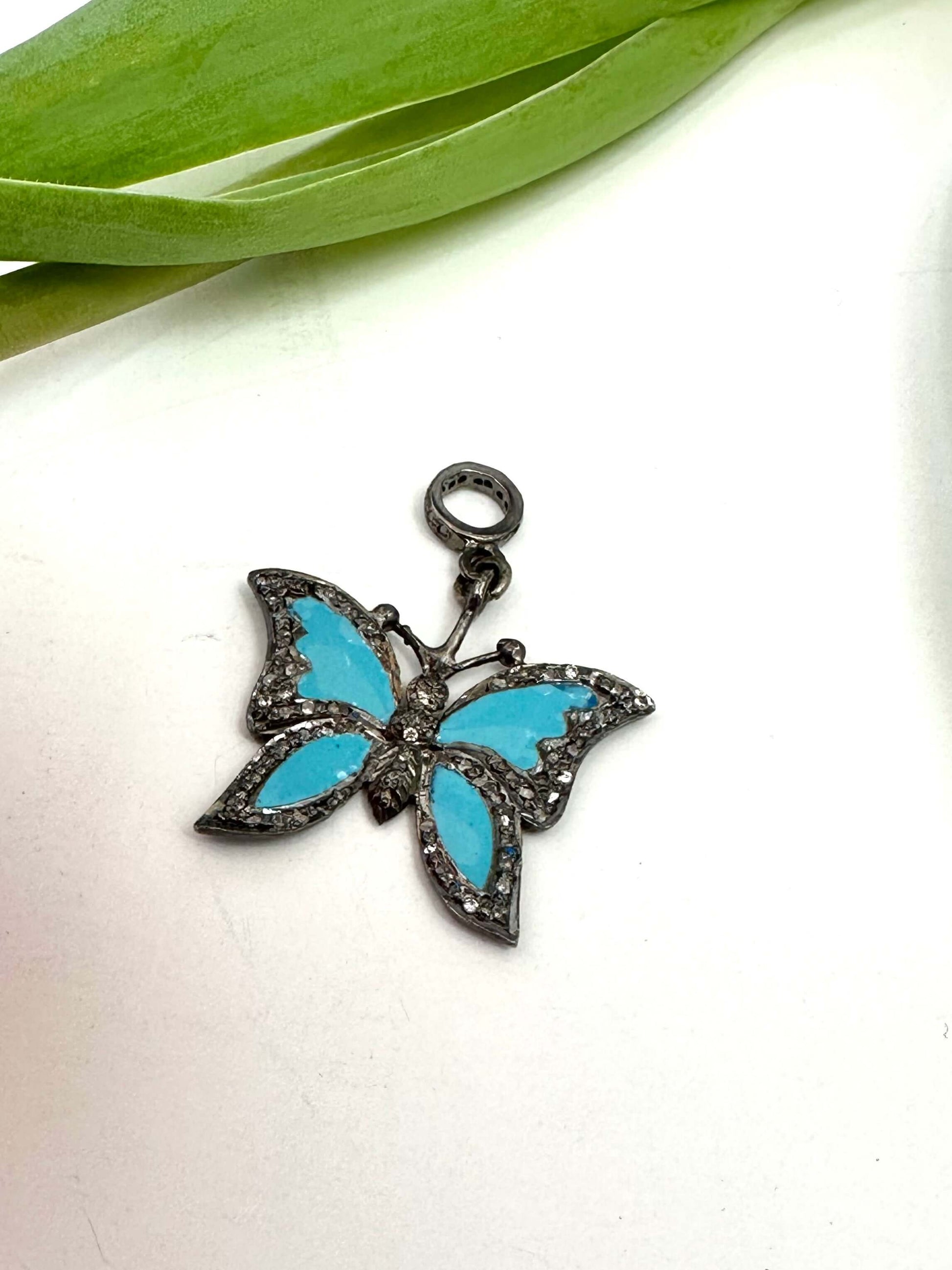 Blue enamel butterfly pendant with diamond pavé in sterling silver, featuring vibrant blue wings and sparkly diamond accents.