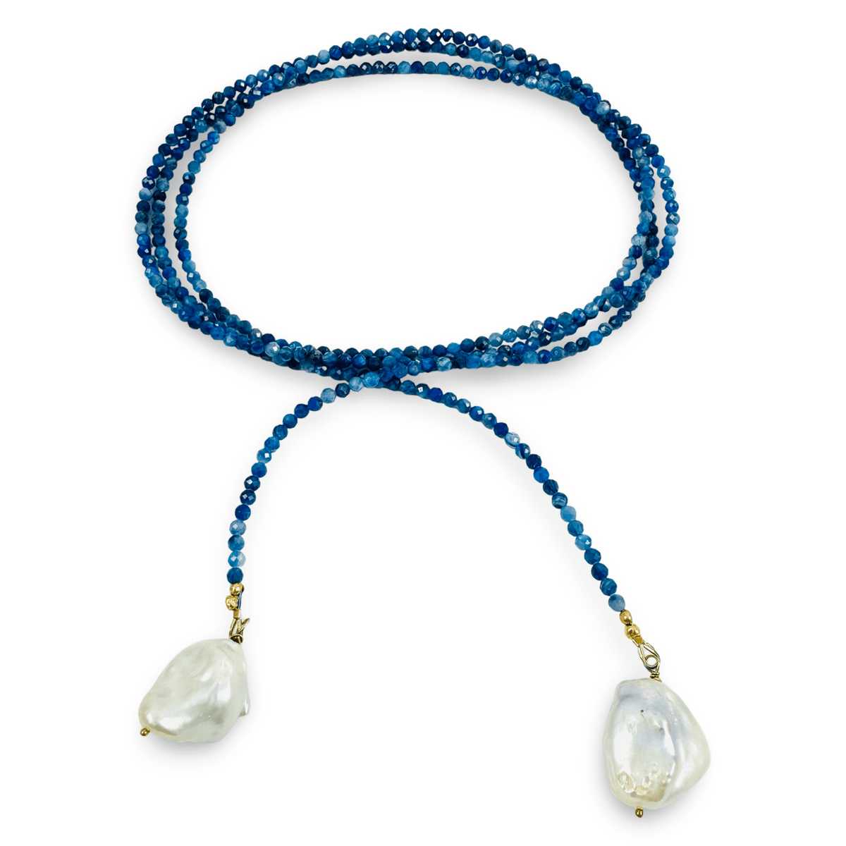 A beaded necklace featuring long strand of deep blue beads, and two large, irregular white baroque shell pendants, displayed on a clean white background.
