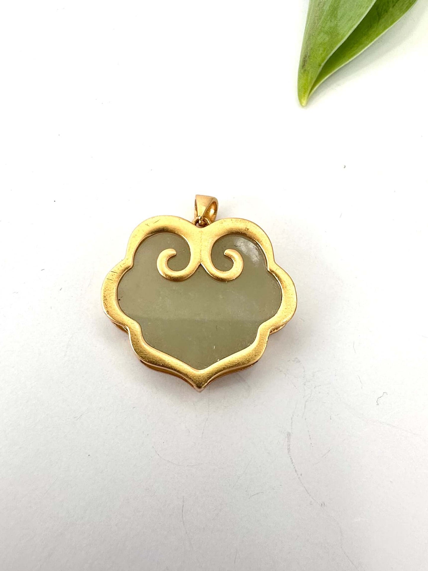 Hotan jade pendant in gold vermeil showcasing polished nephrite jade in an elegant, sculpted silhouette.