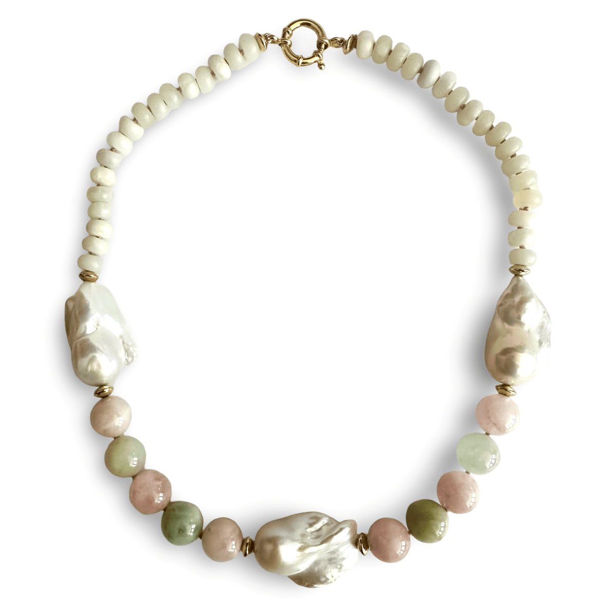 A beaded statement necklace featuring a strand of cream-colored round beads, large irregular mother-of-pearl baroque beads, and smaller polished beads in dusty pink, sage green, and light olive. The necklace is completed with a gold-tone toggle clasp and is displayed on a clean white background.