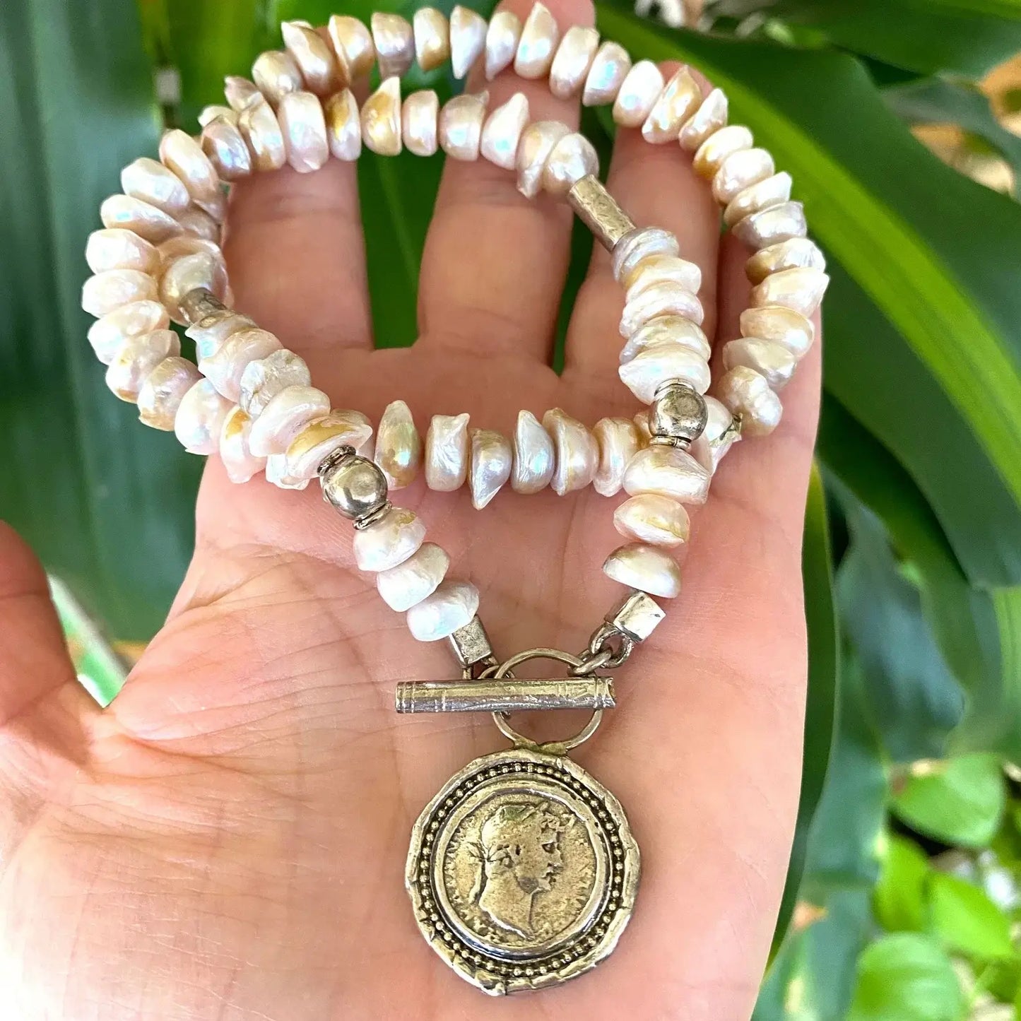 Lavender baroque pearl necklace with silver Roman coin toggle clasp, handcrafted elegance in unique shapes.