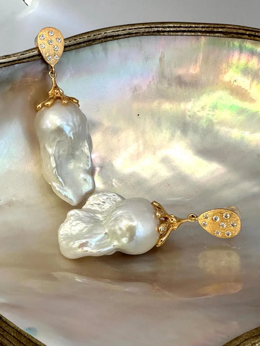 Close-up of Baroque Pearl Gold Vermeil Earrings on white pearl backdrop — handcrafted statement jewelry by Loulia Pearl Jewelry