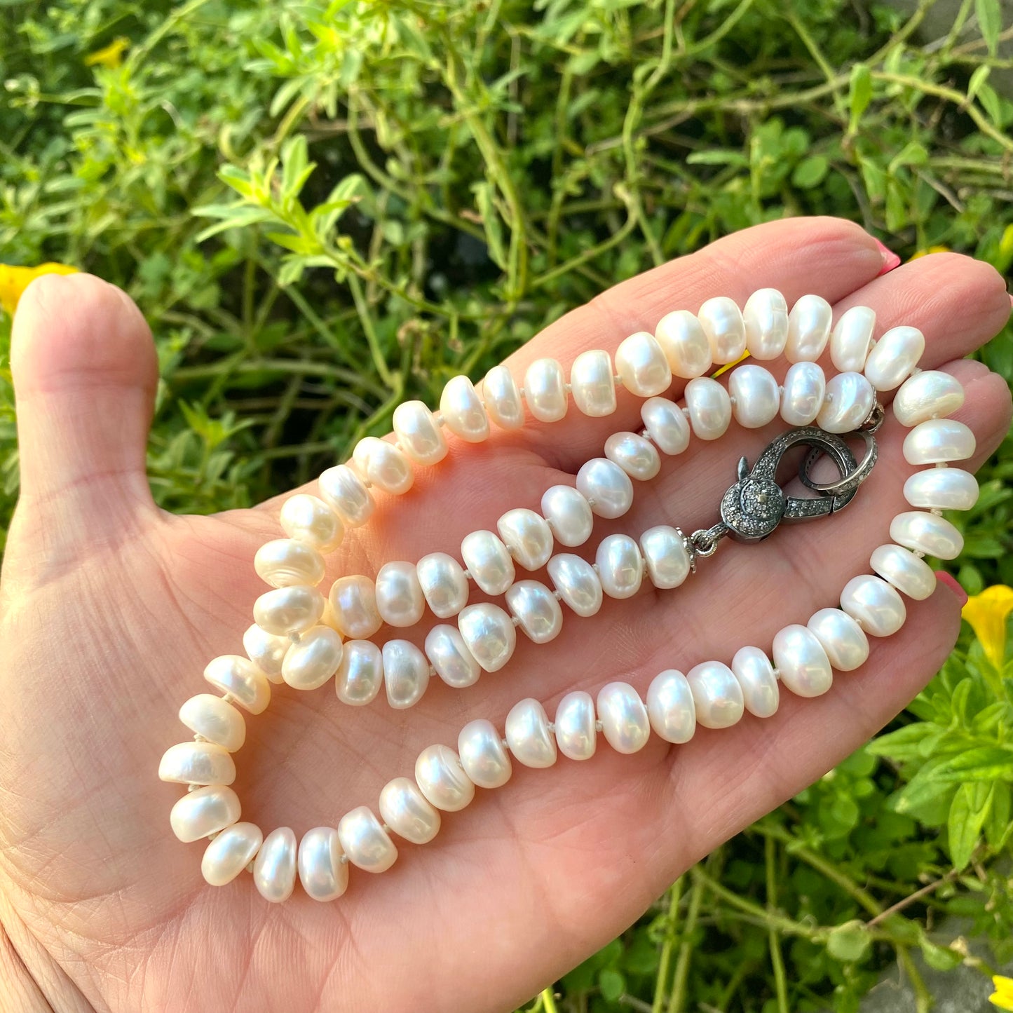 Button pearl necklace with diamond pavé highlighting smooth button pearls and classic strand design