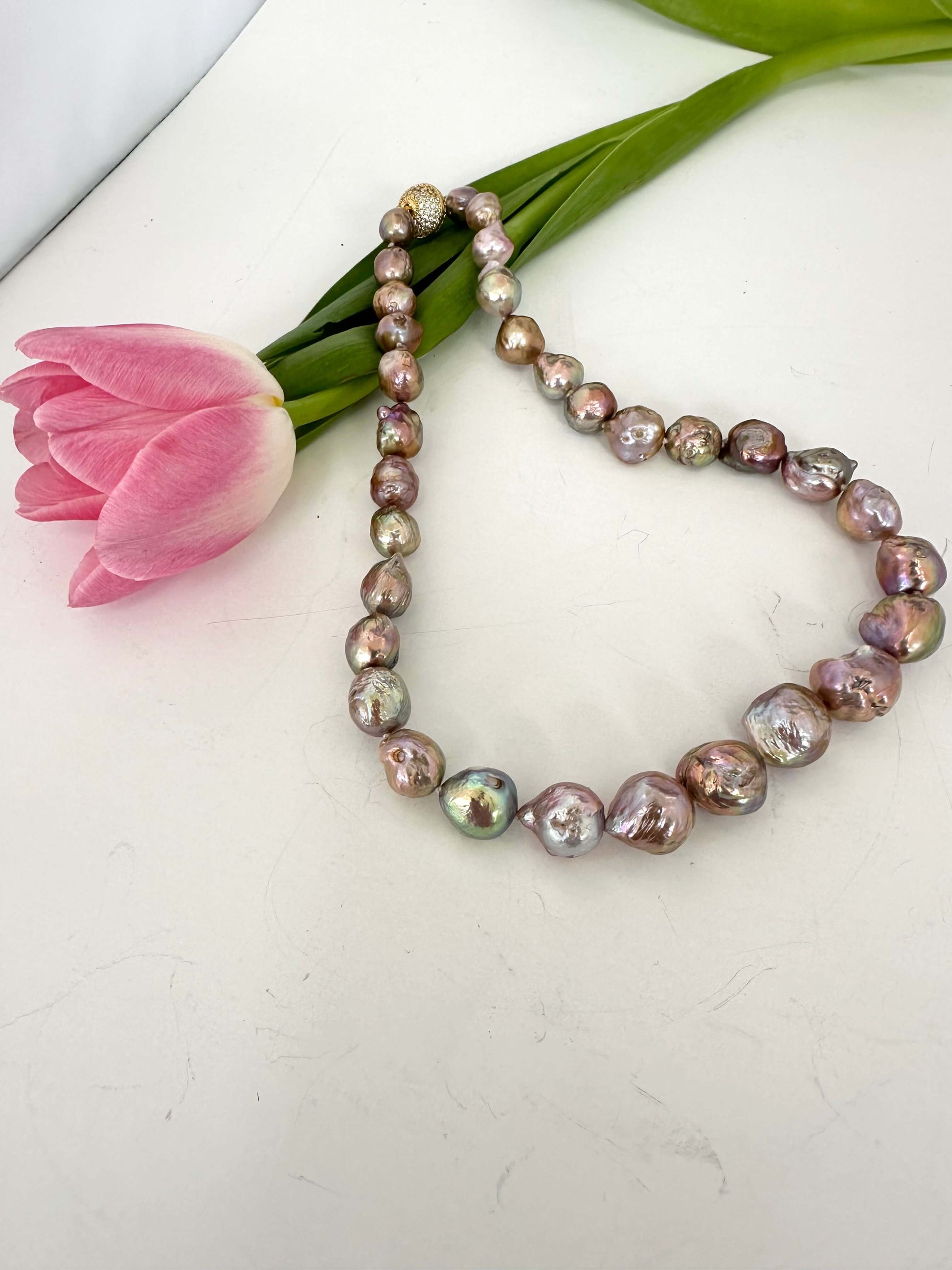 Edison pearl necklace with magnetic clasp laid flat showing baroque avocado pearls