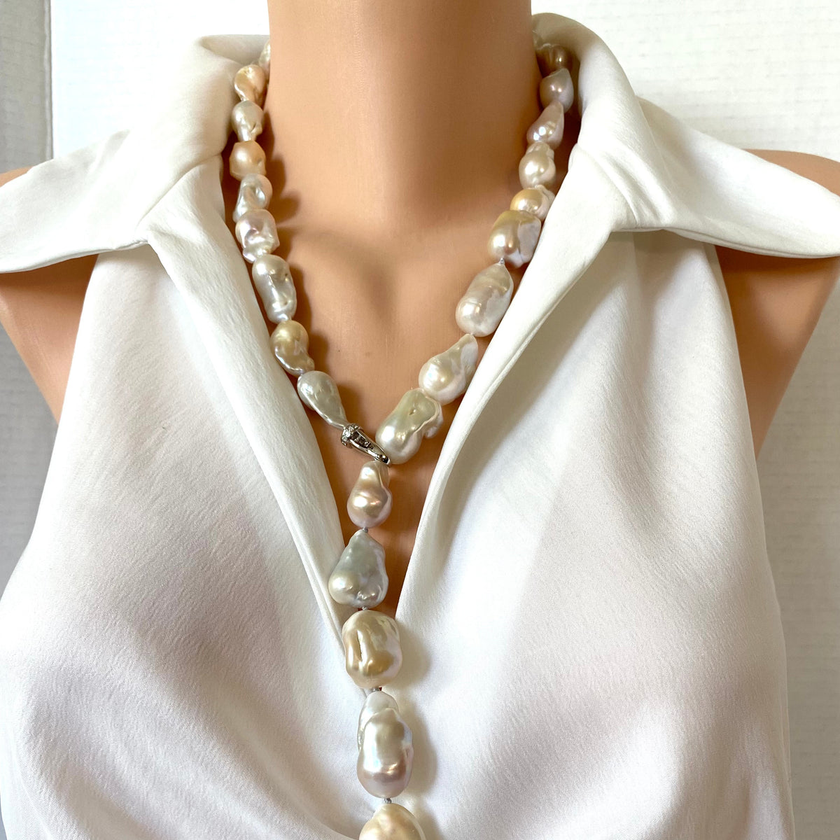 Hand knotted with large freshwater baroque pearls in natural shades of white, ivory, beige and soft blush, this 29-inch necklace brings together dramatic size and effortless versatility.