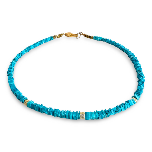 A turquoise beaded necklace with textured, disc-like beads and small gold spacer accents, displayed on a clean white background.