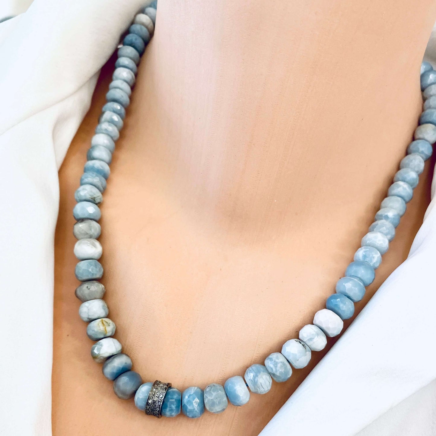 Boulder opal diamond necklace close-up with natural opal color variation