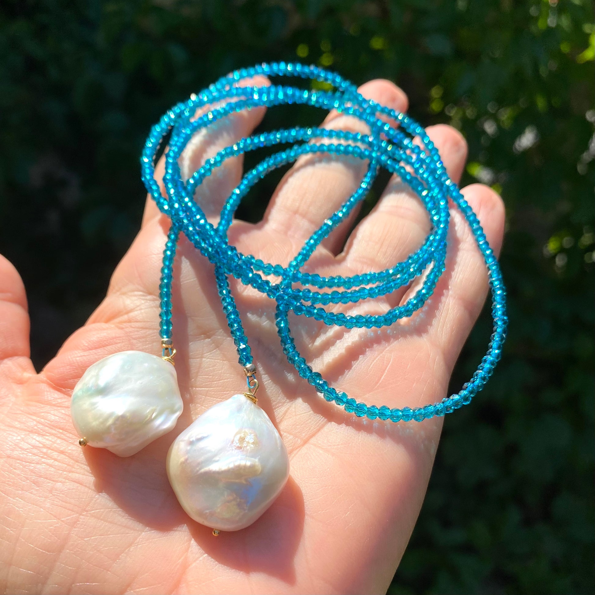 London Blue Quartz Lariat Necklace in hand, coiled strand with two large baroque pearl ends