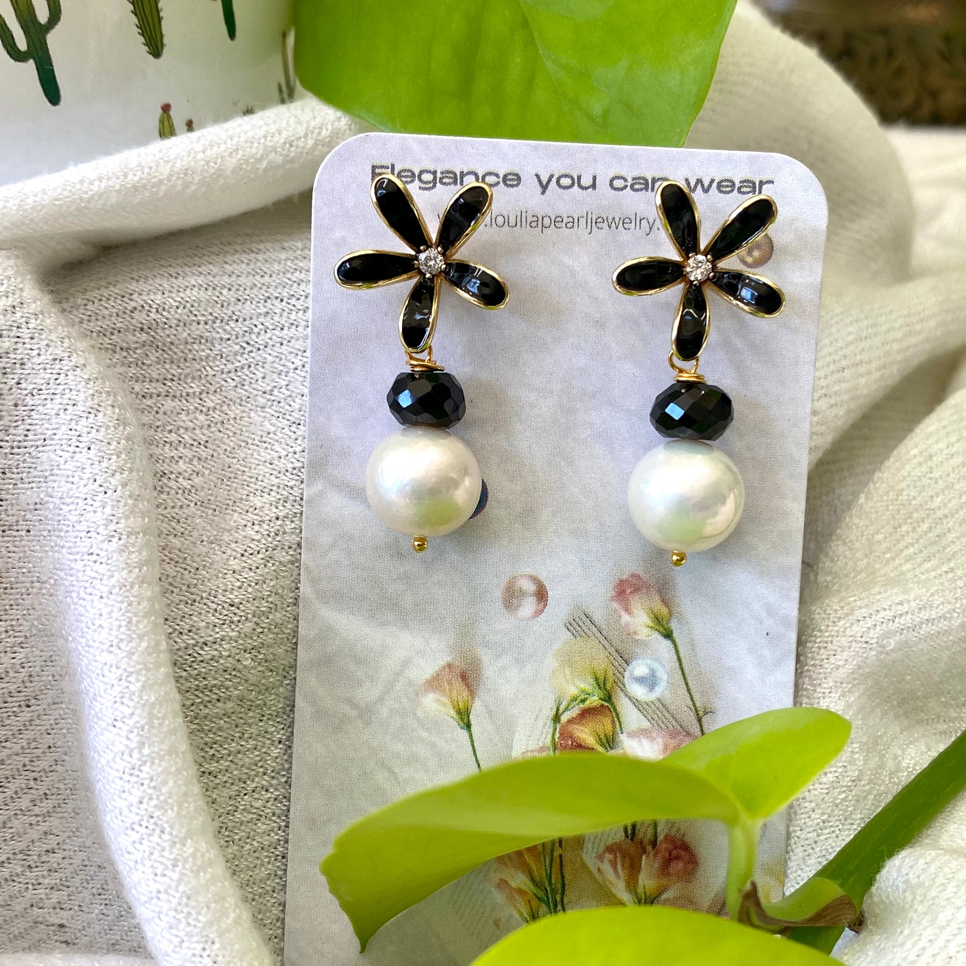 Edison pearl black spinel earrings worn on model, white Edison pearl drops with black enamel flower studs