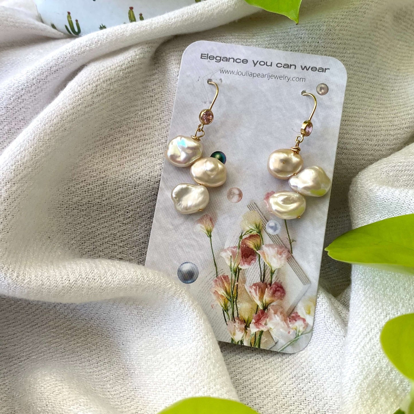 Elegant earrings composed of Natural Keshi pink and white pearls hanging from gold filled hooks with pink cubic zirconia bezel
