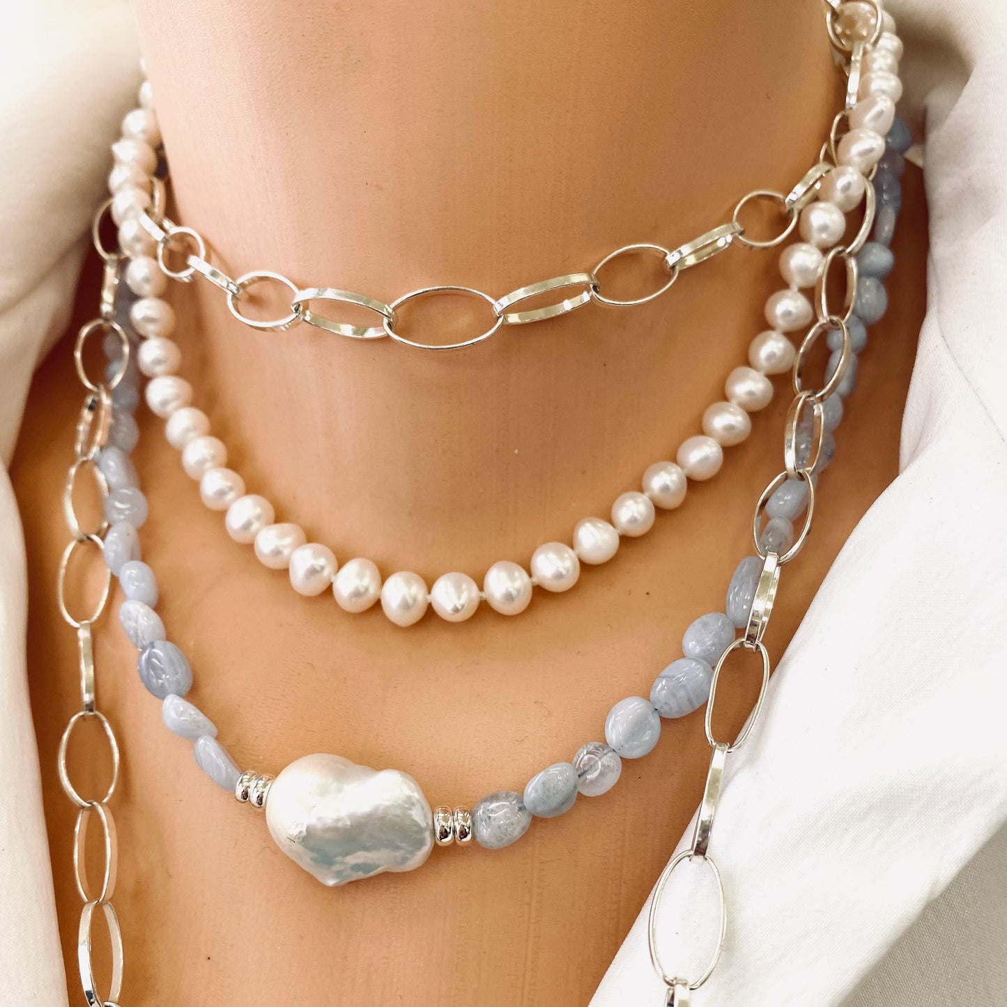 Blue lace agate pearl necklace layered with silver chain and pearl necklaces