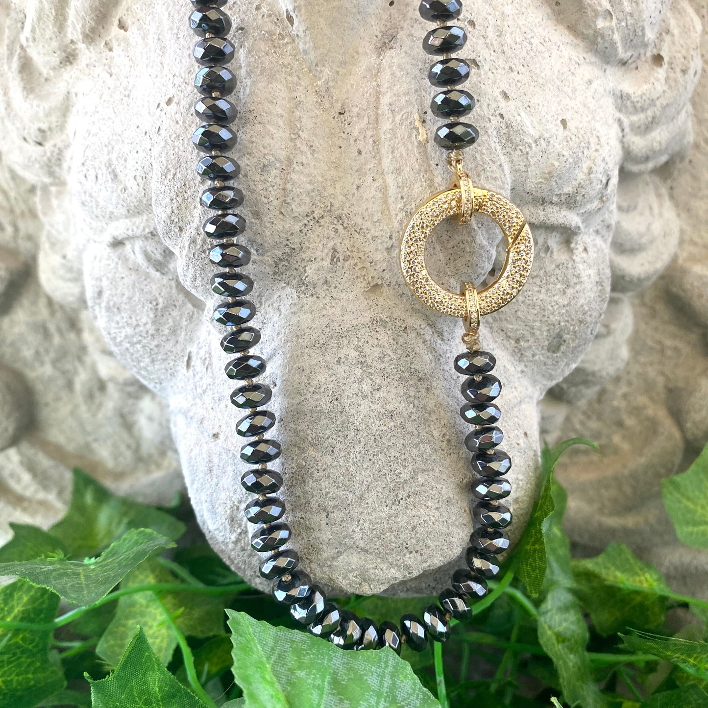 Festive Hematite Necklace featuring faceted beads and a gold clasp, showcasing playful elegance and colorful statement jewelry.