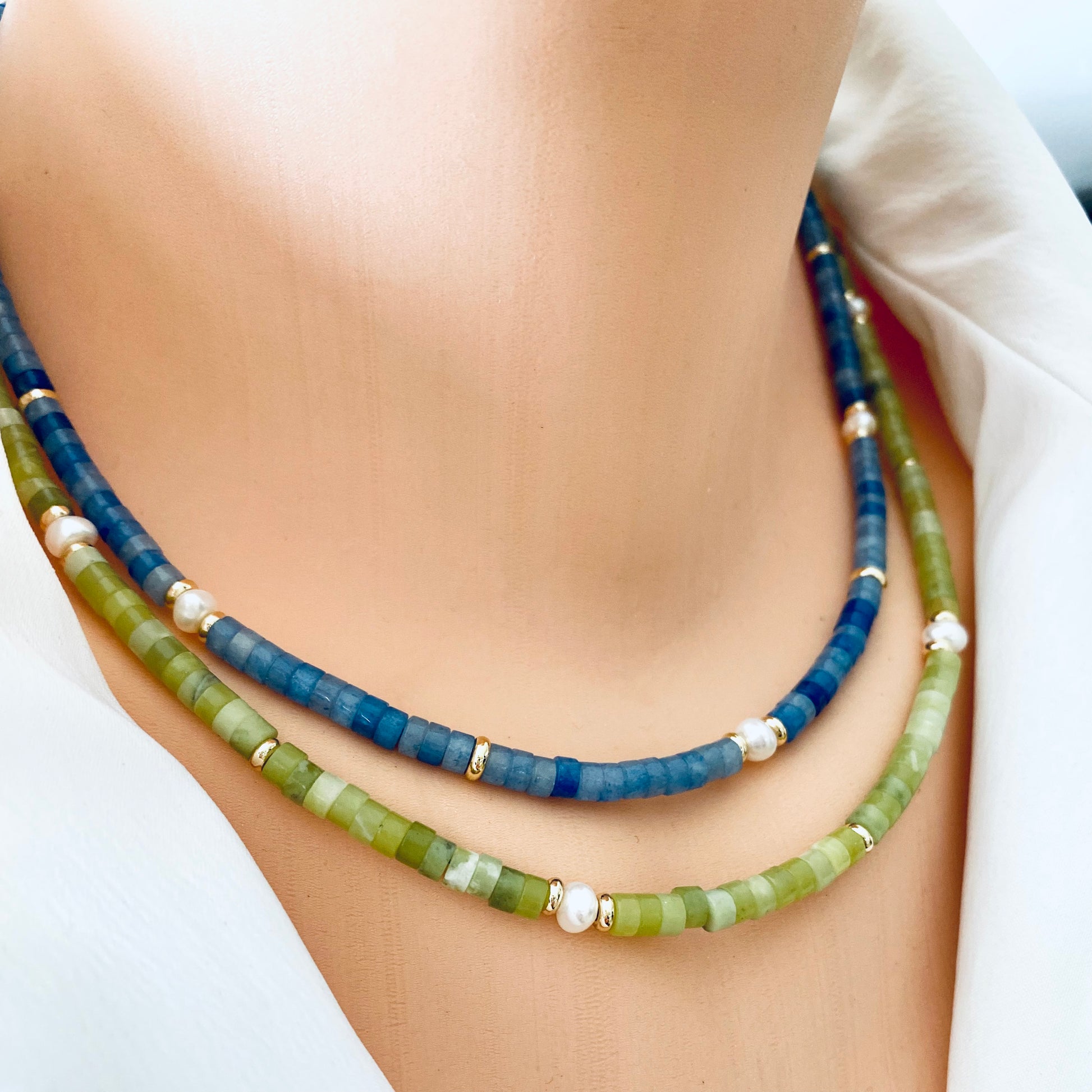 Multi gemstone choker necklaces worn layered with green and blue gemstone beads
