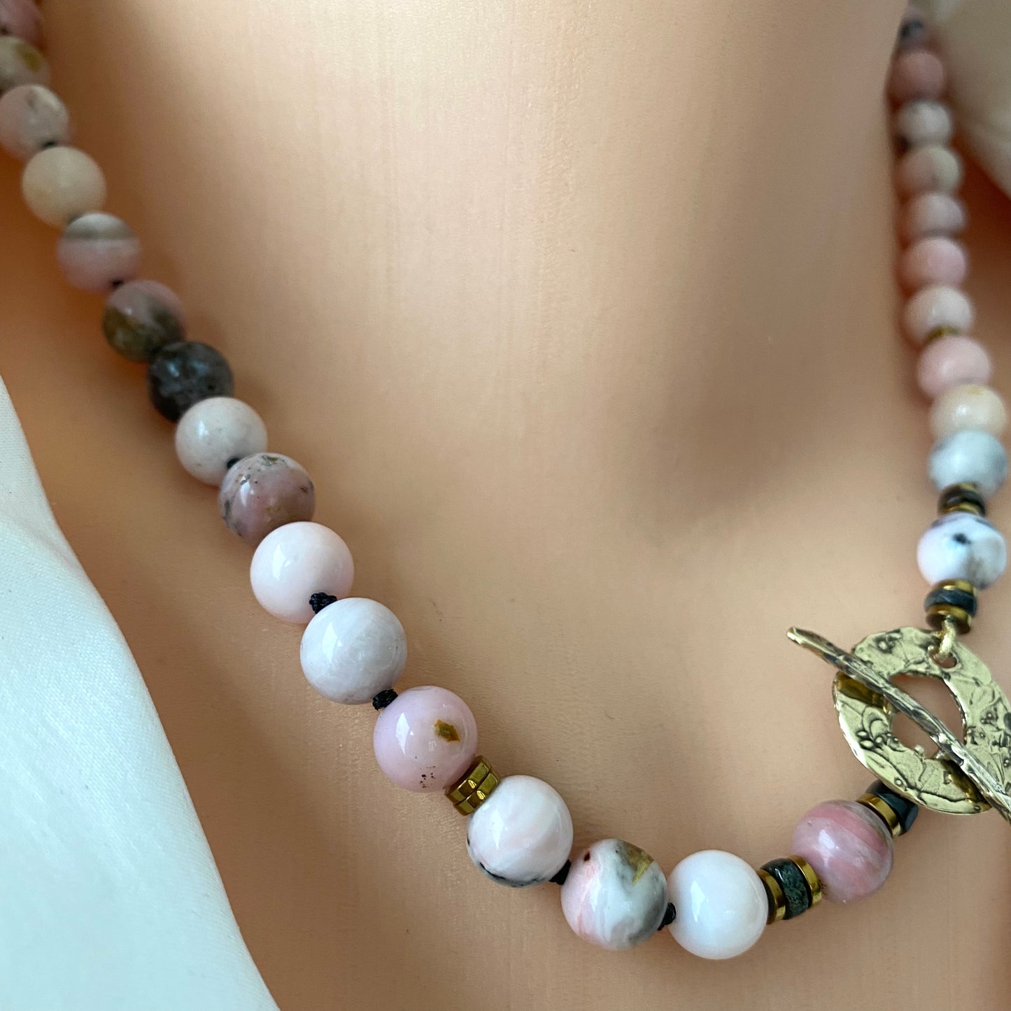 Pink opal hematite necklace close up showing pink opal beads and hematite details