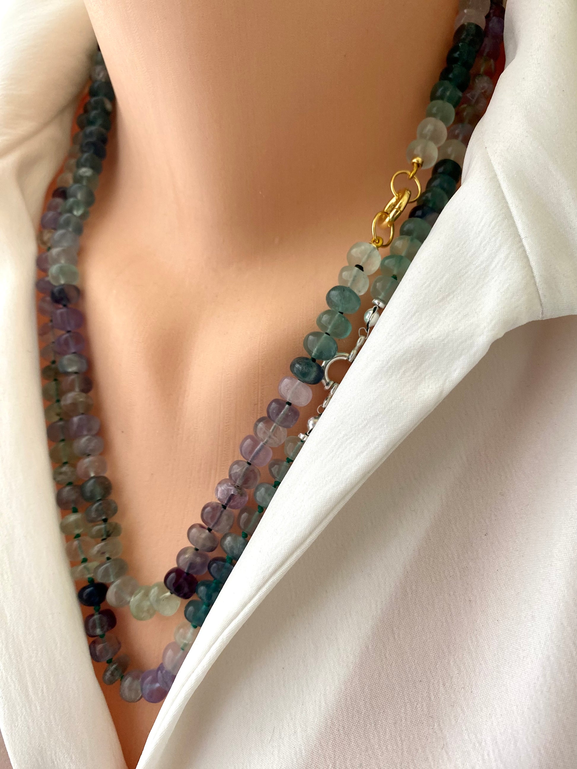 Fluorite candy necklace showcasing multi-color rondelle beads with gold clasp worn on a mannequin.