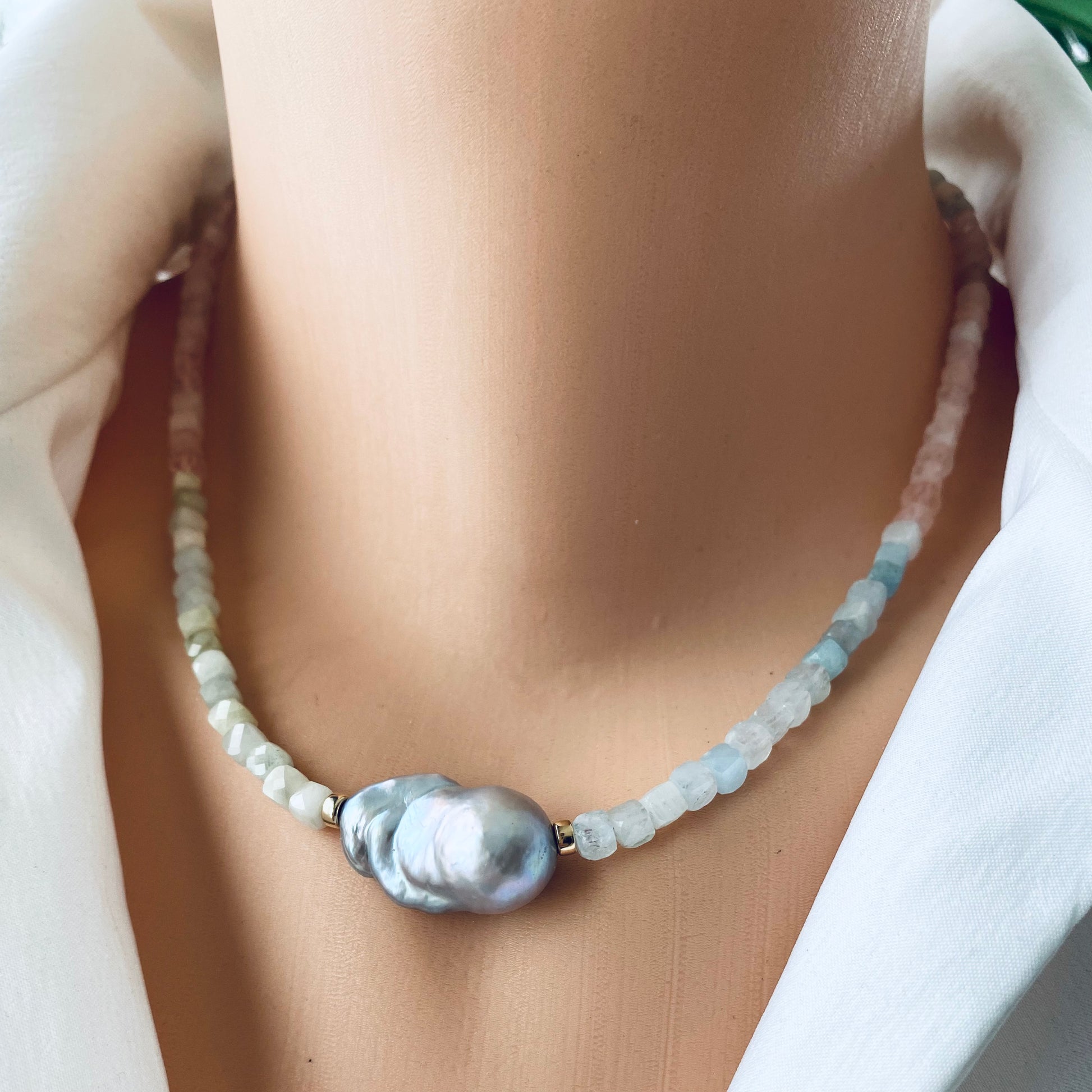 Aquamarine morganite pearl necklace close up showing aquamarine morganite beads and grey pearl