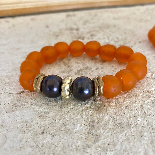 Black pearl glass bracelet with orange African recycled beads, handcrafted with large freshwater black baroque pearls.
