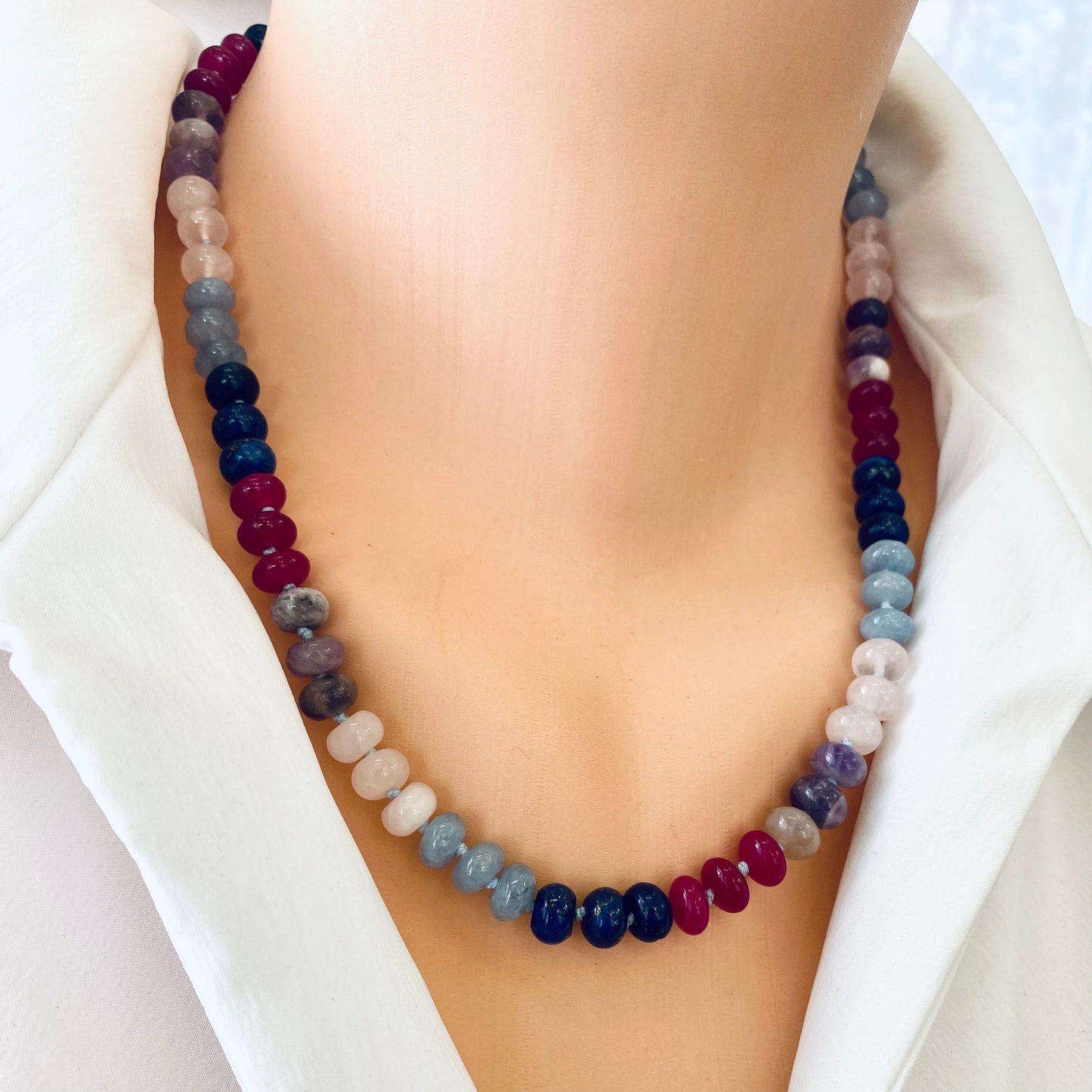 Denim candy necklace with lapis lazuli, rose quartz, and jade beads displayed on a mannequin.