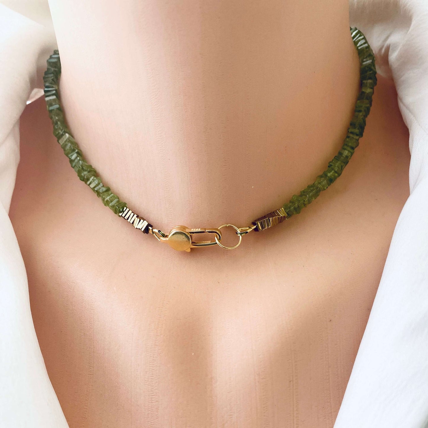 Peridot choker necklace featuring natural green peridot beads, showcasing a modern and elegant design for jewelry enthusiasts.