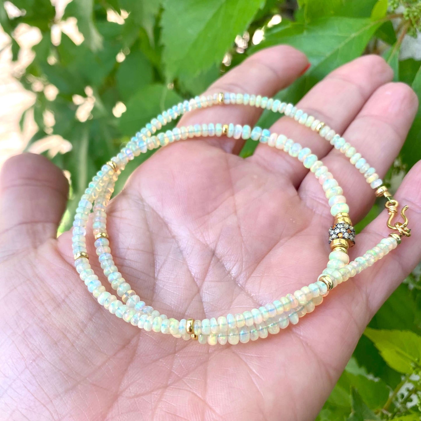 Ethiopian opal necklace in hand, Ethiopian opal rondelles and multi sapphire pavé detail close-up