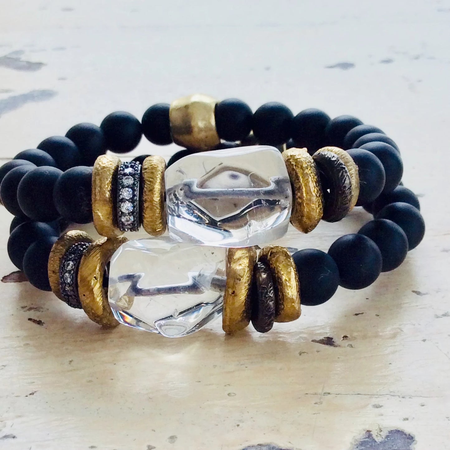 Crystal Quartz Onyx Bracelet featuring faceted quartz and black onyx beads with gold accents.